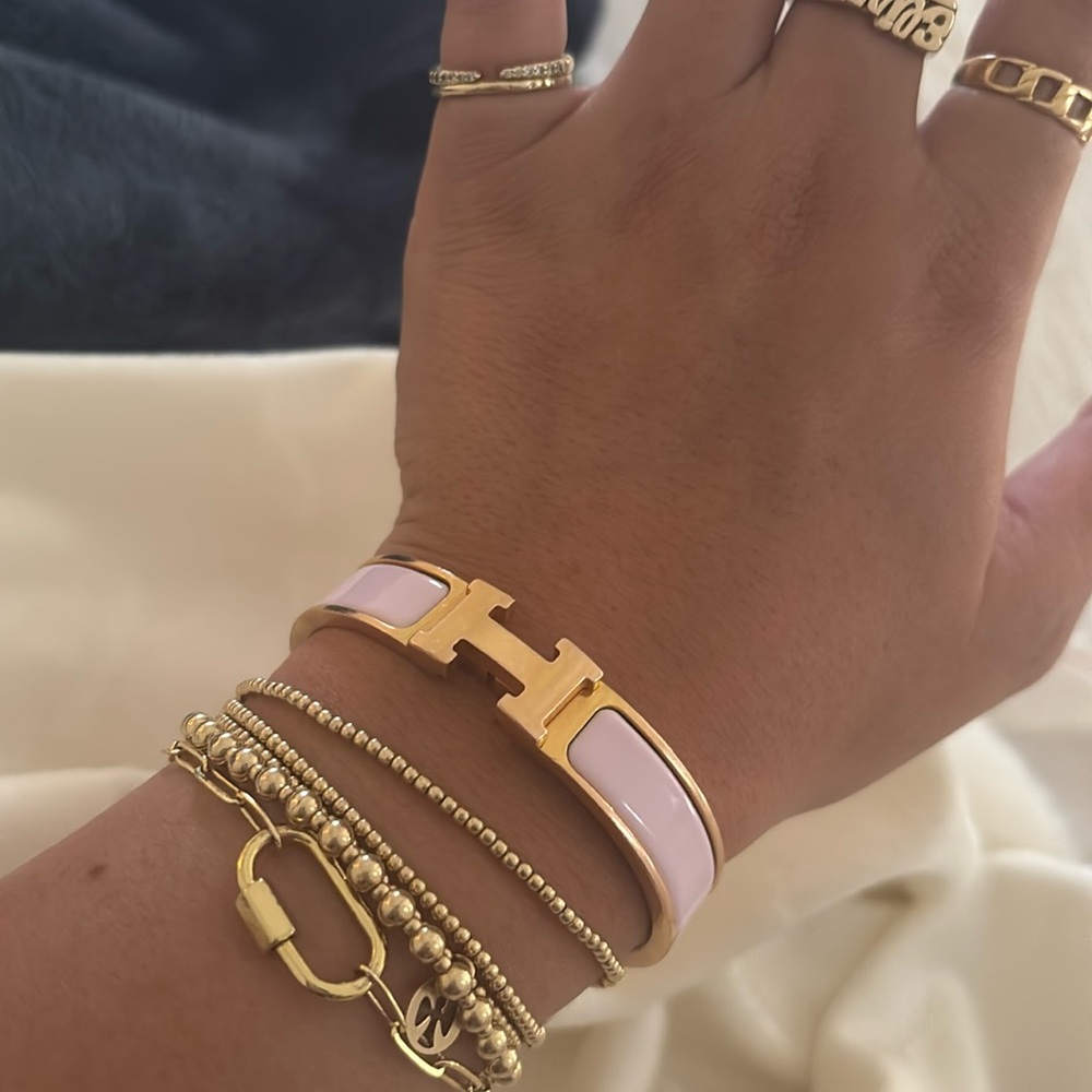 Hermes H Clic bracelet in light pink with gold setting.